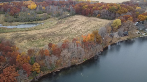 Again the lot shows the woods at the lake with it being just right of center of the photo at the lakefront