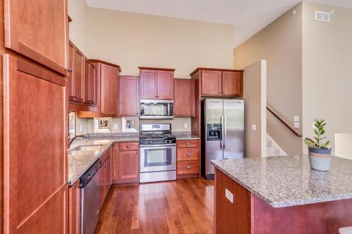 This end unit townhome is filled with beautiful upgrades! The Kitchen features custom cherry cabinets and granite countertops.