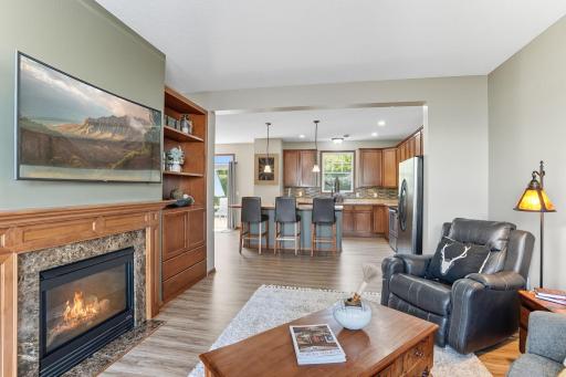 Built-in bookcase with extra storage as well as open to the large kitchen area.