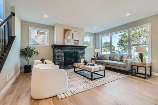 Main floor great room with gas fireplace with cultured stone surround