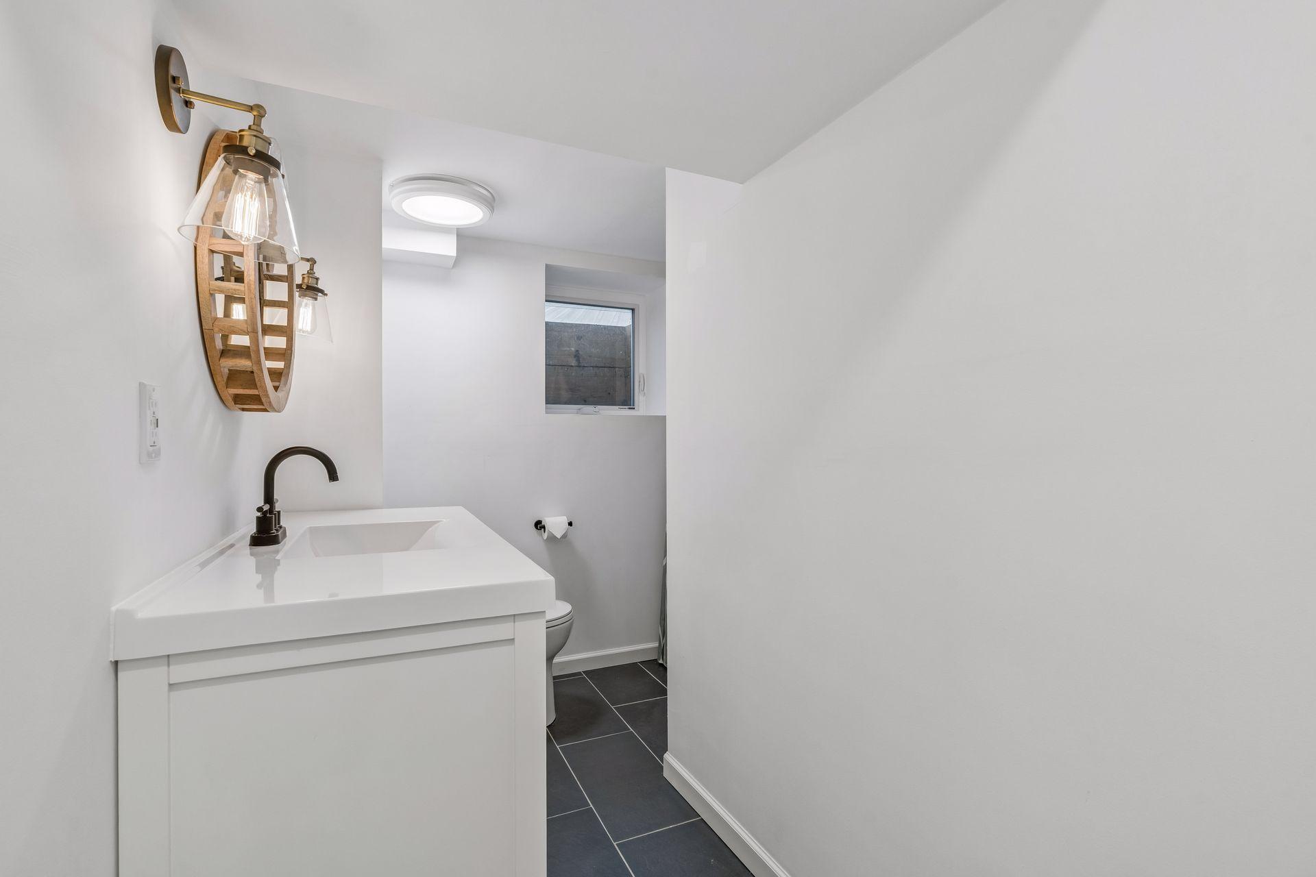 Lower level 3/4 bath with tile floor and walk-in shower with overhead waterfall shower head!