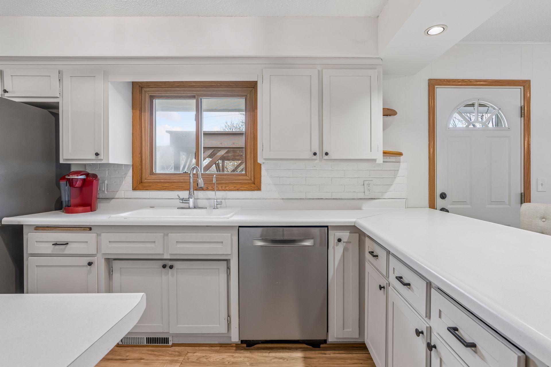 Kitchen window overlooks backyard and the patio and pergola. New garbage disposal installed August 2025.