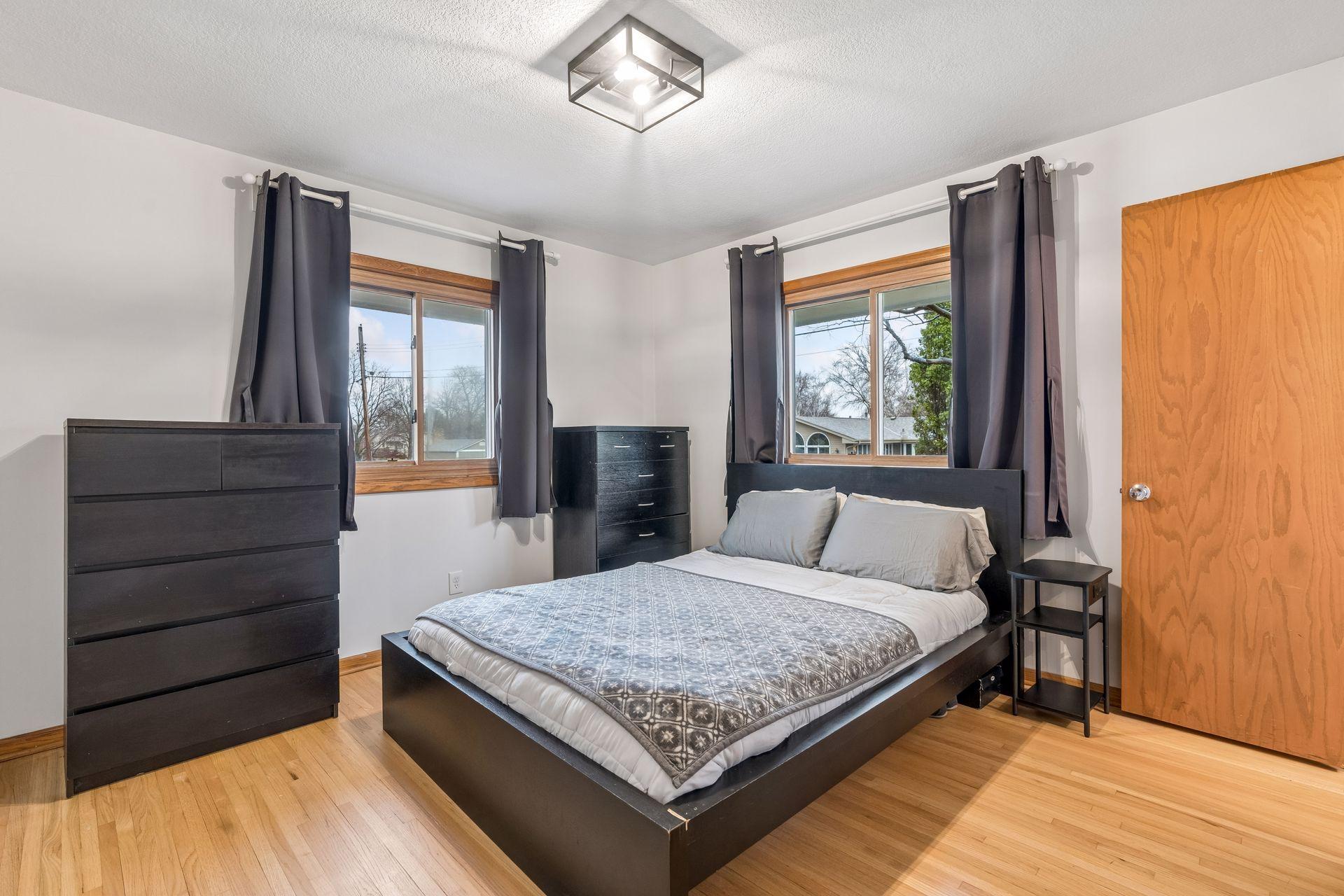 One of three main floor bedrooms - all with oak hardwood floors. The primary suite includes a half bath.