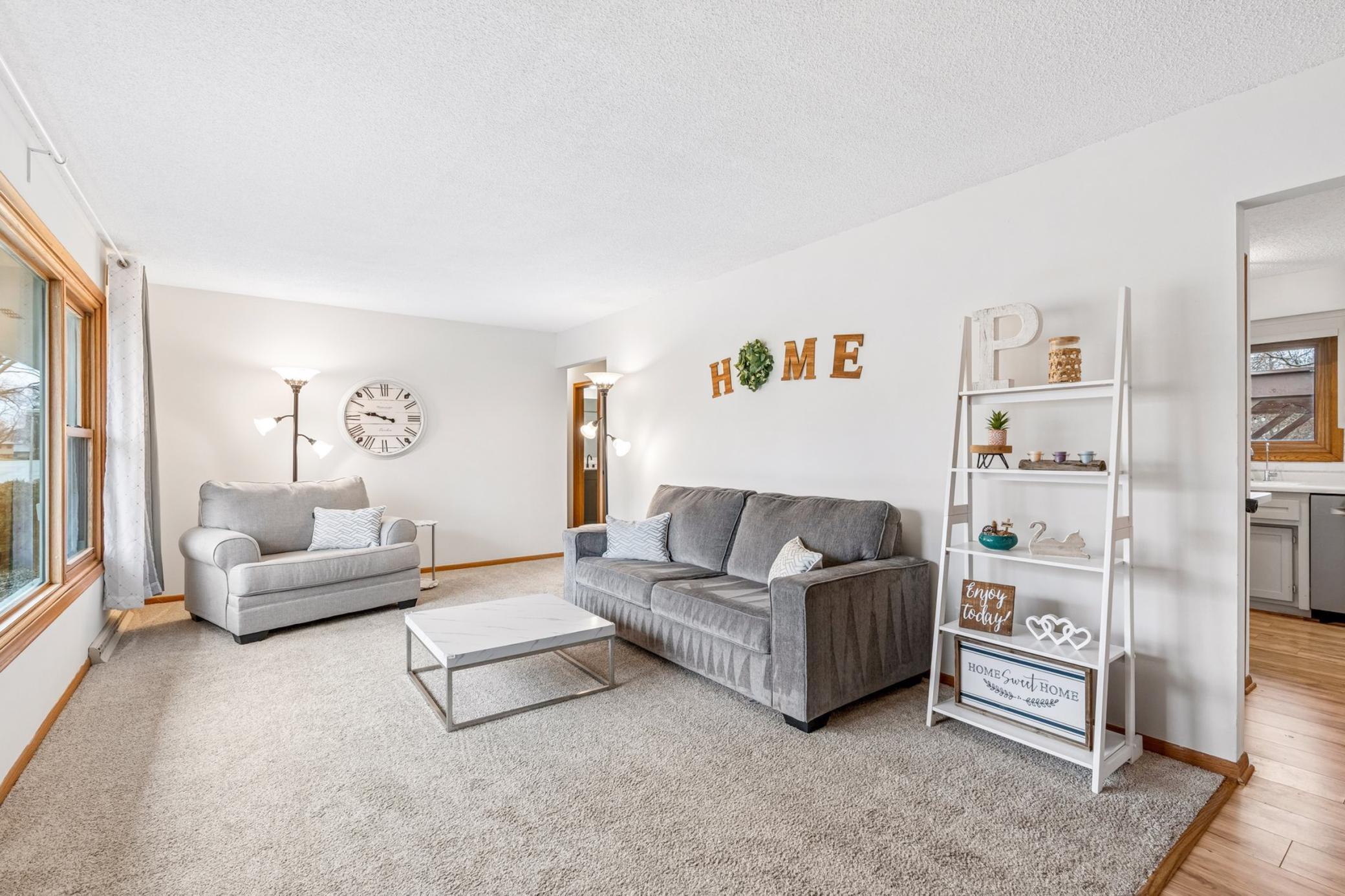 Home offers a flowing open floor plan with access to the kitchen/dining from both sides of the living room.