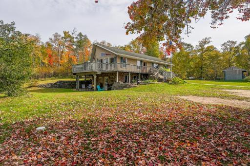 Back Exterior – Walkout lower level with covered patio and an upper deck overlooking the spacious yard.