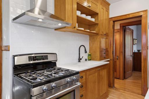 Quartz counter tops & maple flooring. The microwave is tucked away in a cabinet to keep the counter space tidy.
