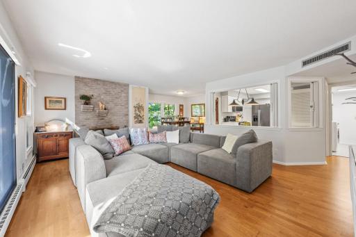 Welcome to unit 115! Bright and Spacious Living Room Inviting open-concept living area with large windows, hardwood floors, and plenty of natural light.