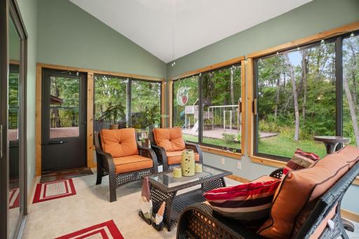 Lovely 3 season porch with nature views leads to the maintenance free deck.