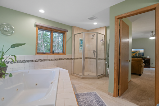 Another view of this impressive bathroom with tile floors and huge jetted tub.