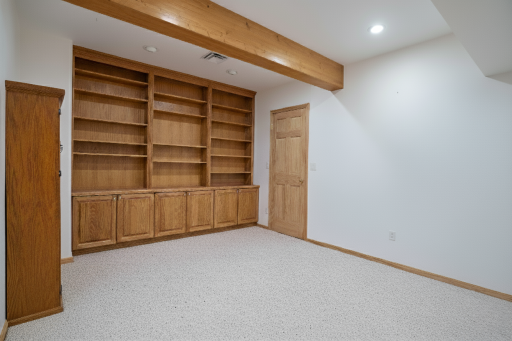 The library complete with wonderful built-ins for all your displaying needs. Would make a great hobby room, or workout space too.