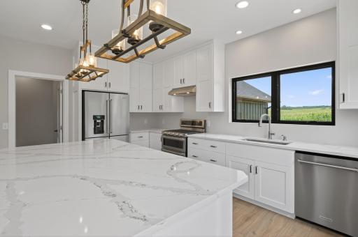 Worried that a cabinet-depth refrigerator isn't enough room? Located in the island is a beverage cooler and a double-drawer fridge.