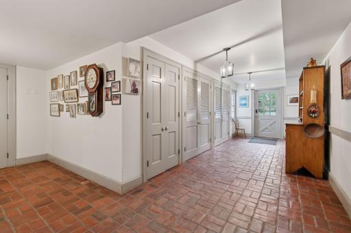 Behind these doors is a large unfinished space with wood fireplace, currently used as storage.