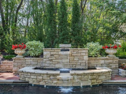 Tranquil water feature that flows into pool