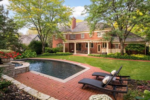 Designed for outdoor living the backyard unfolds into a private oasis with a heated pool and expansive patio
