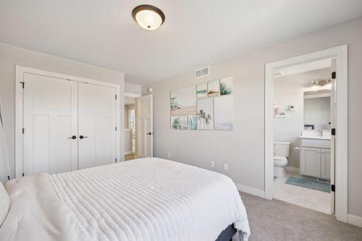 Another comfortable guest bedroom features its own private ensuite, offering convenience and privacy for visiting family or friends