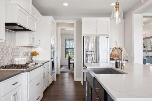 This chef-inspired kitchen features a spacious farm sink and a sleek 6-burner counter stove, blending function with style