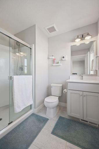 The private guest bathroom features a sleek walk-in shower