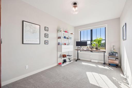 The main floor bedroom, currently used as an office, offers inspiring views of the surrounding wetlands