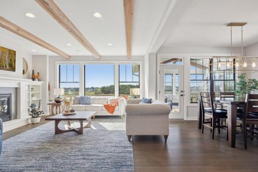 The living room and informal dining area offer scenic views and direct access to the new three-season porch, perfect for seamless indoor-outdoor living