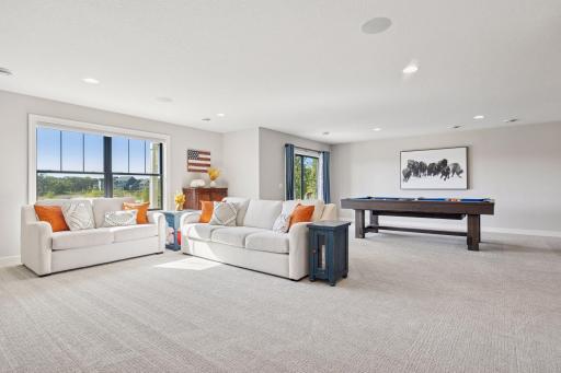 The walk-out lower level family room offers generous space for comfortable seating and plenty of room for a pool table or other amusements