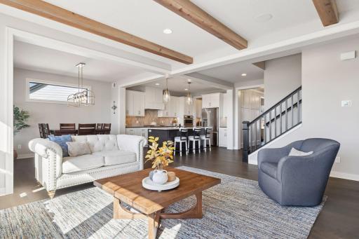 The living room flows seamlessly into the kitchen and informal dining area, creating a spacious, connected layout perfect for everyday living and entertaining