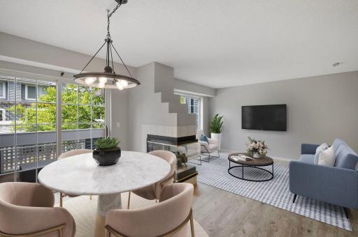 The open concept main level boasts large windows and a 2 sided fireplace