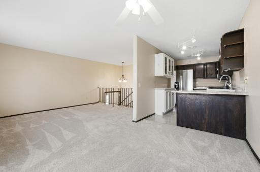 Dining Area with Living Room, Kitchen, and steps to lower level.