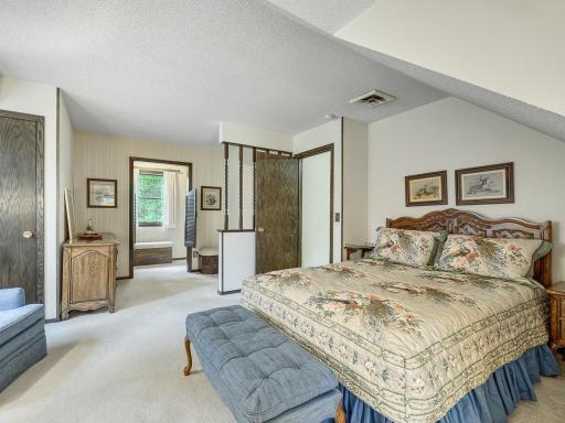 Primary bedroom with walk in closet that could be enlarged by using attic space in garage.