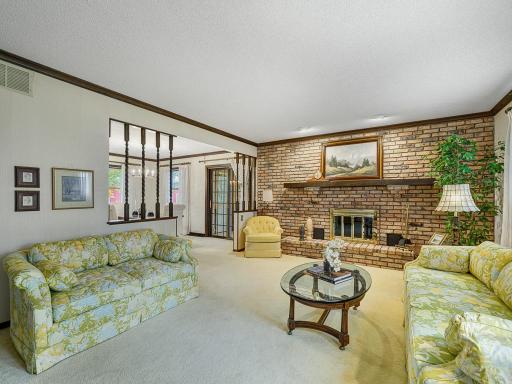 Full wall brick fireplace in formal living room.