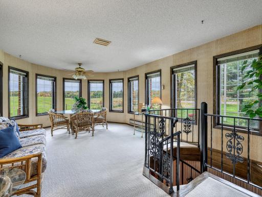 South facing sunroom leads to lower level library.