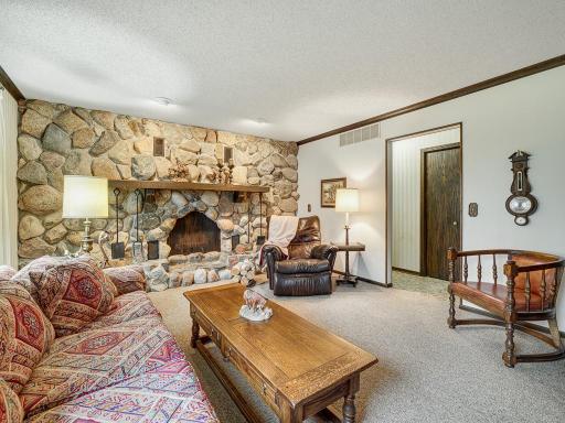 Cozy up by this full wall stone fireplace in main floor family room with homemade mantel from the farm's wood.