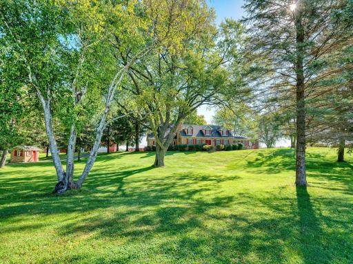 Lightly rolling terrain in the front yard of this beautiful home.