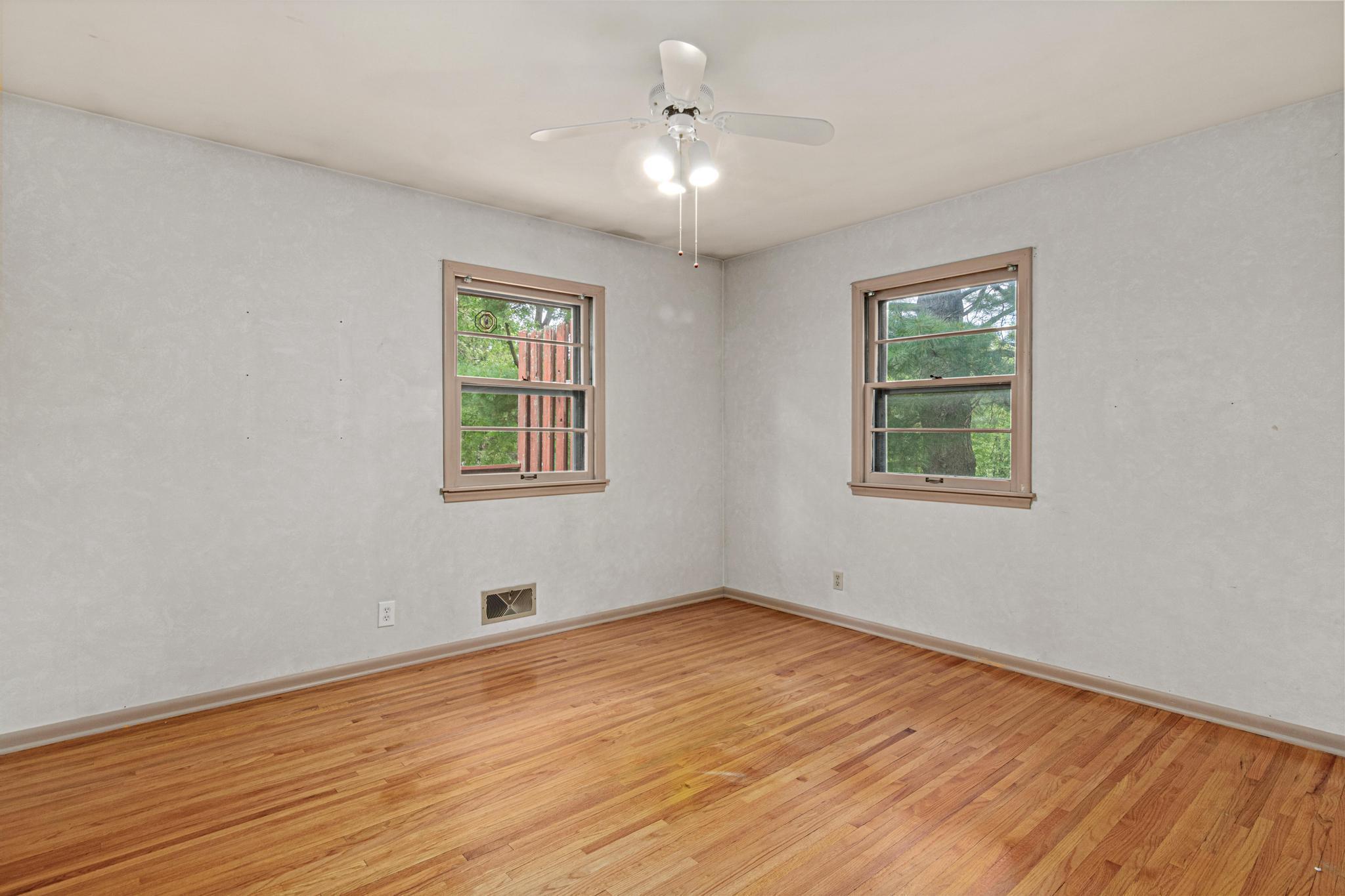 Private Primary Bedroom #1 on Main Level facing backyard!
