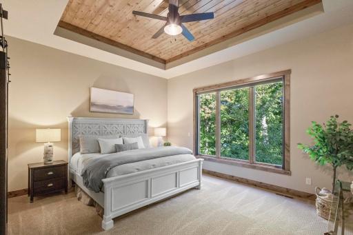The primary suite with views of the backyard