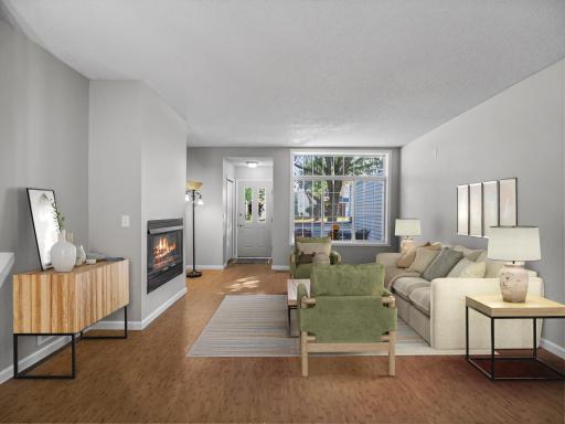 4205 Merrimac Ln. N #59 - This sunlit living room, virtually staged, offers an open layout and welcoming warmth. Envision cozy evenings and stylish gatherings in this comfortable, elegant space.