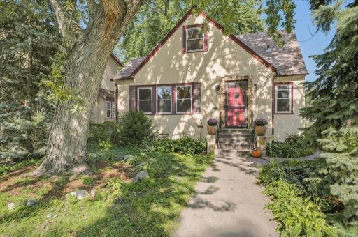 Nice front curb appeal with stucco exterior and mature trees