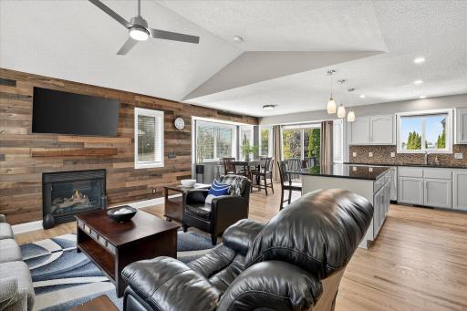 Open vaulted main level Living Room with hardwood floors and cozy gas fireplace