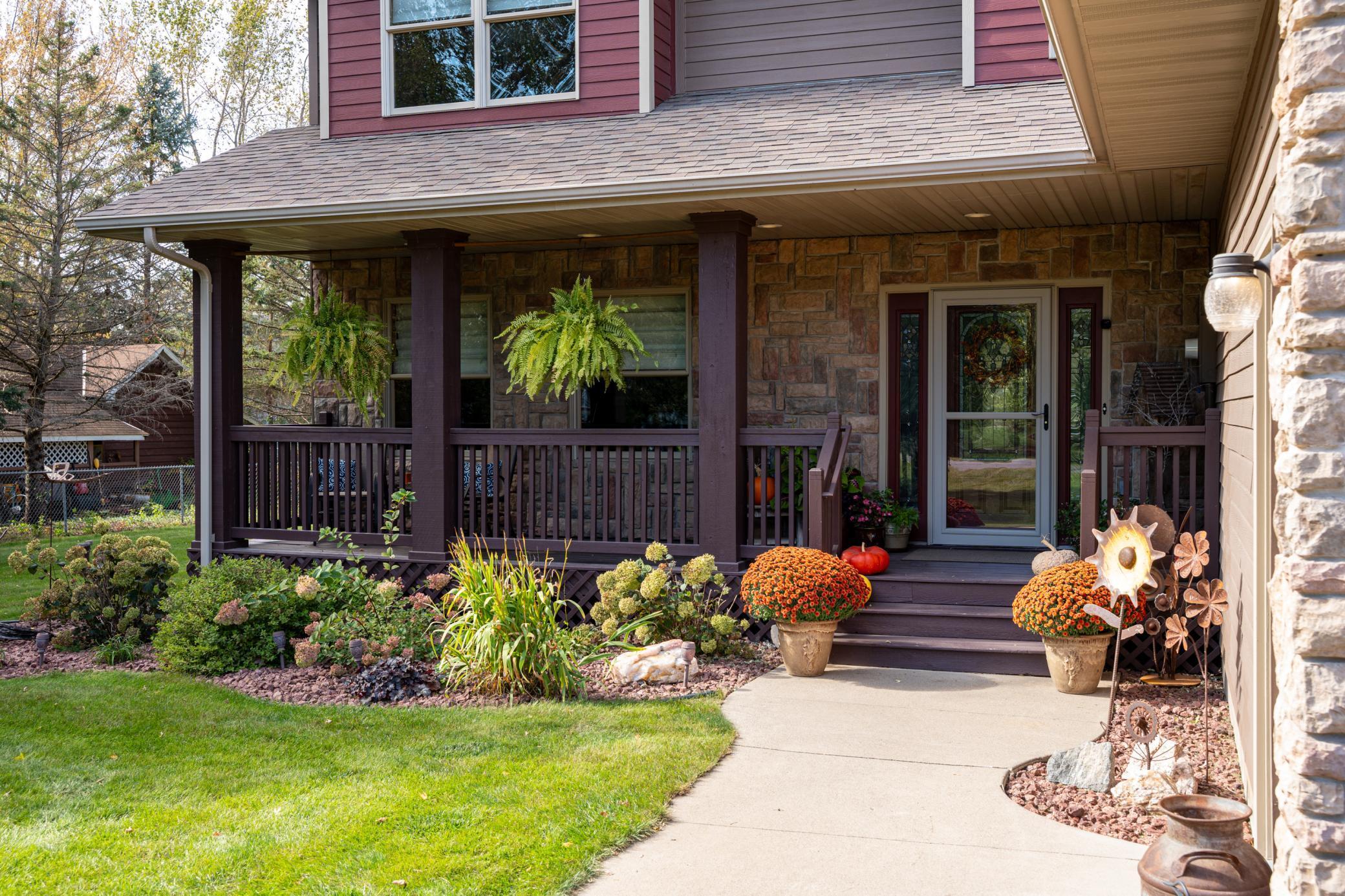 A lovely covered front porch with soffit lighting.
