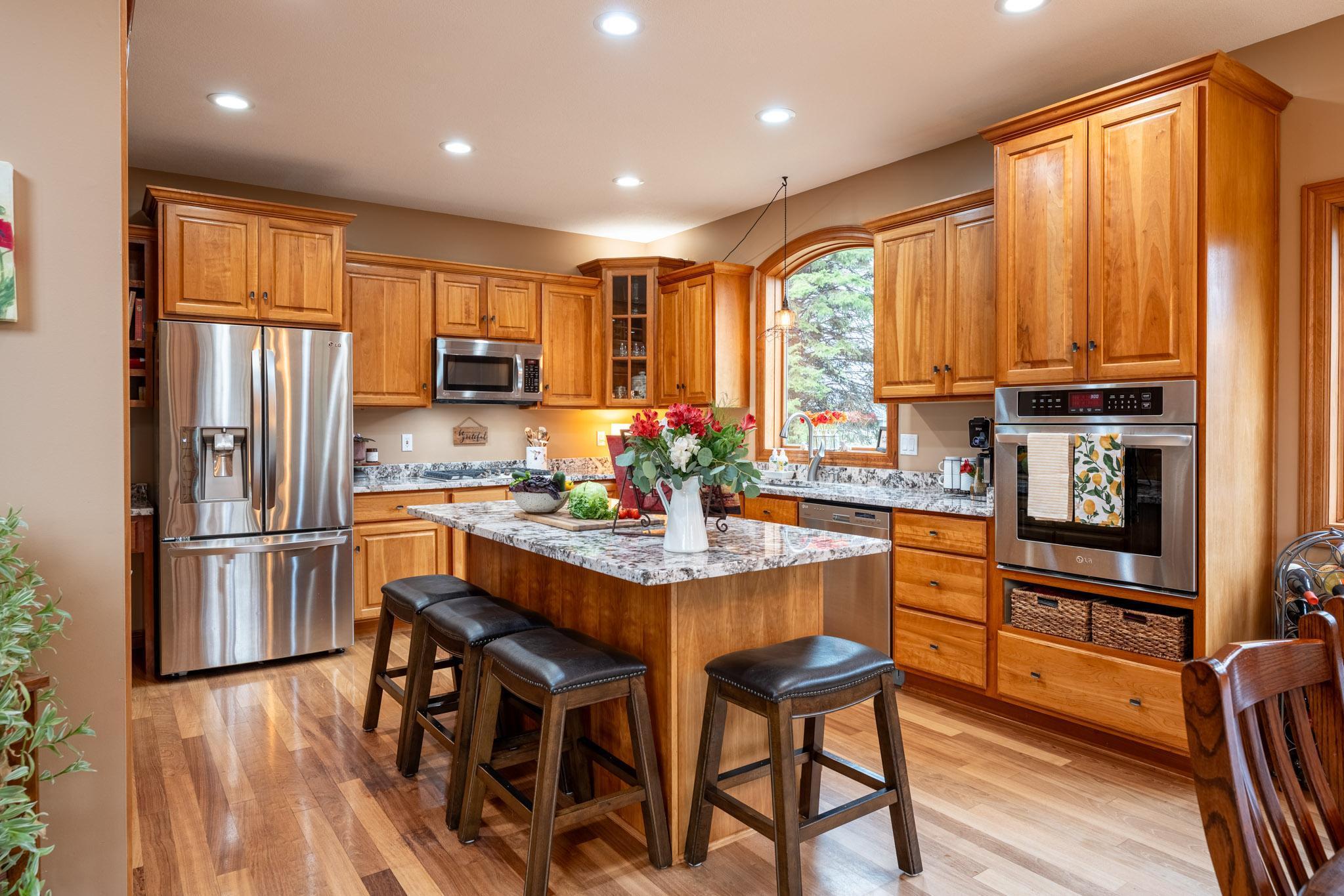 Featuring granite counters, stainless steel appliances, center island seating, and an informal dining area with access to a large 22.5 x 20 ft deck.