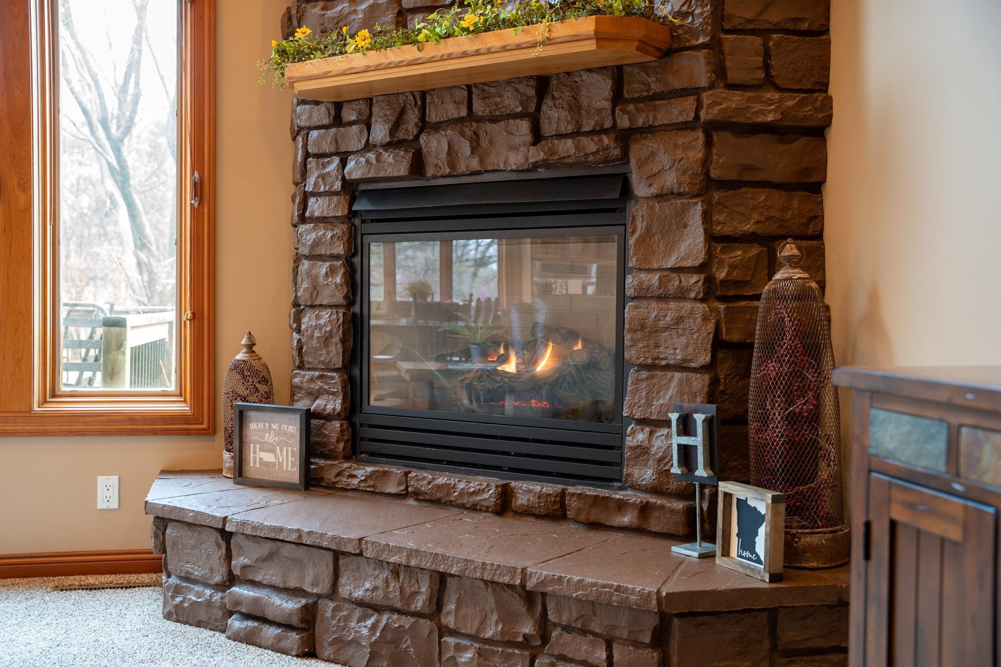 The stone gas fireplace is the focal point of the living room.
