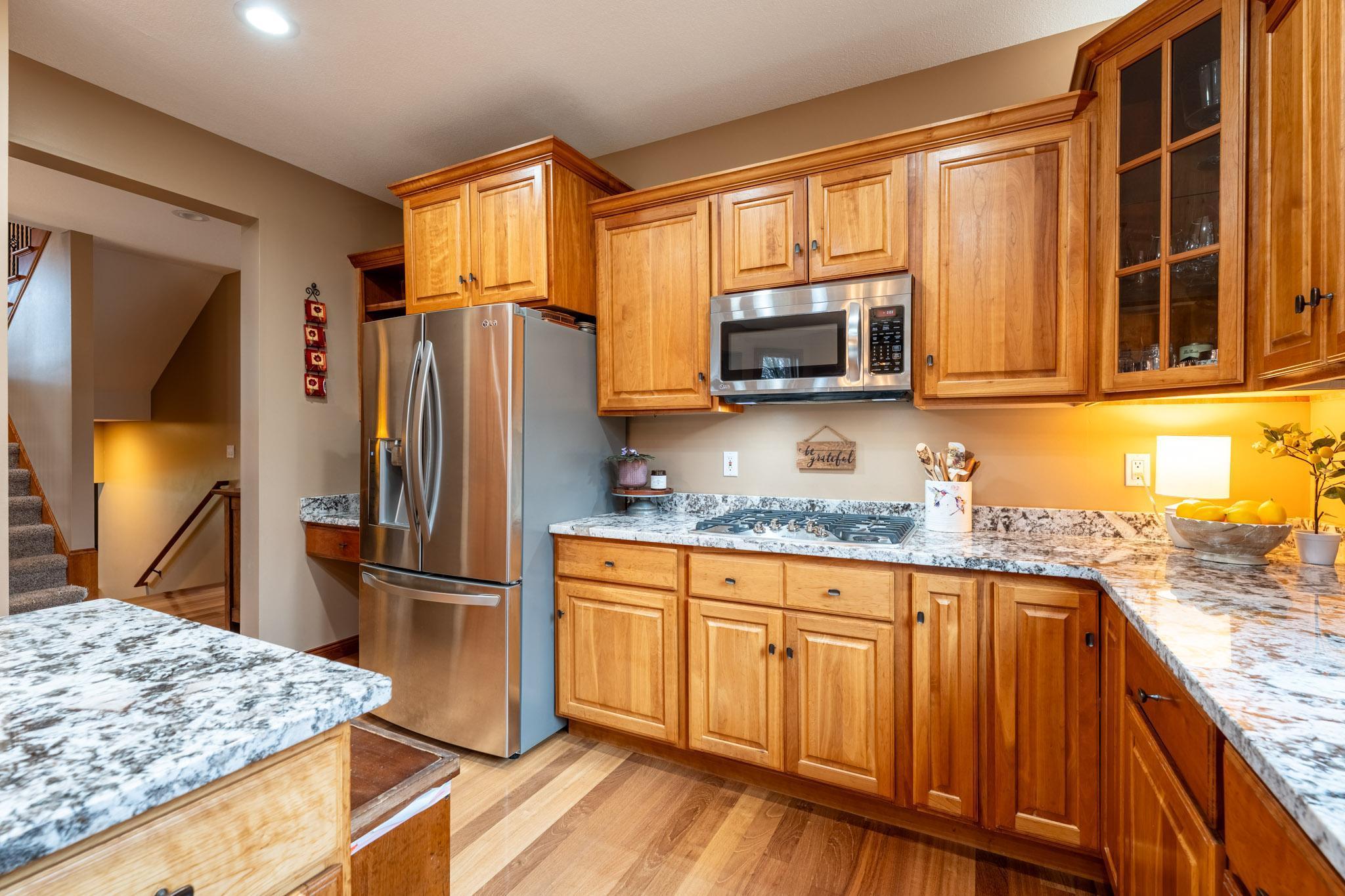 Stainless steel appliances complement this chef-ready kitchen - new cooktop 2022.