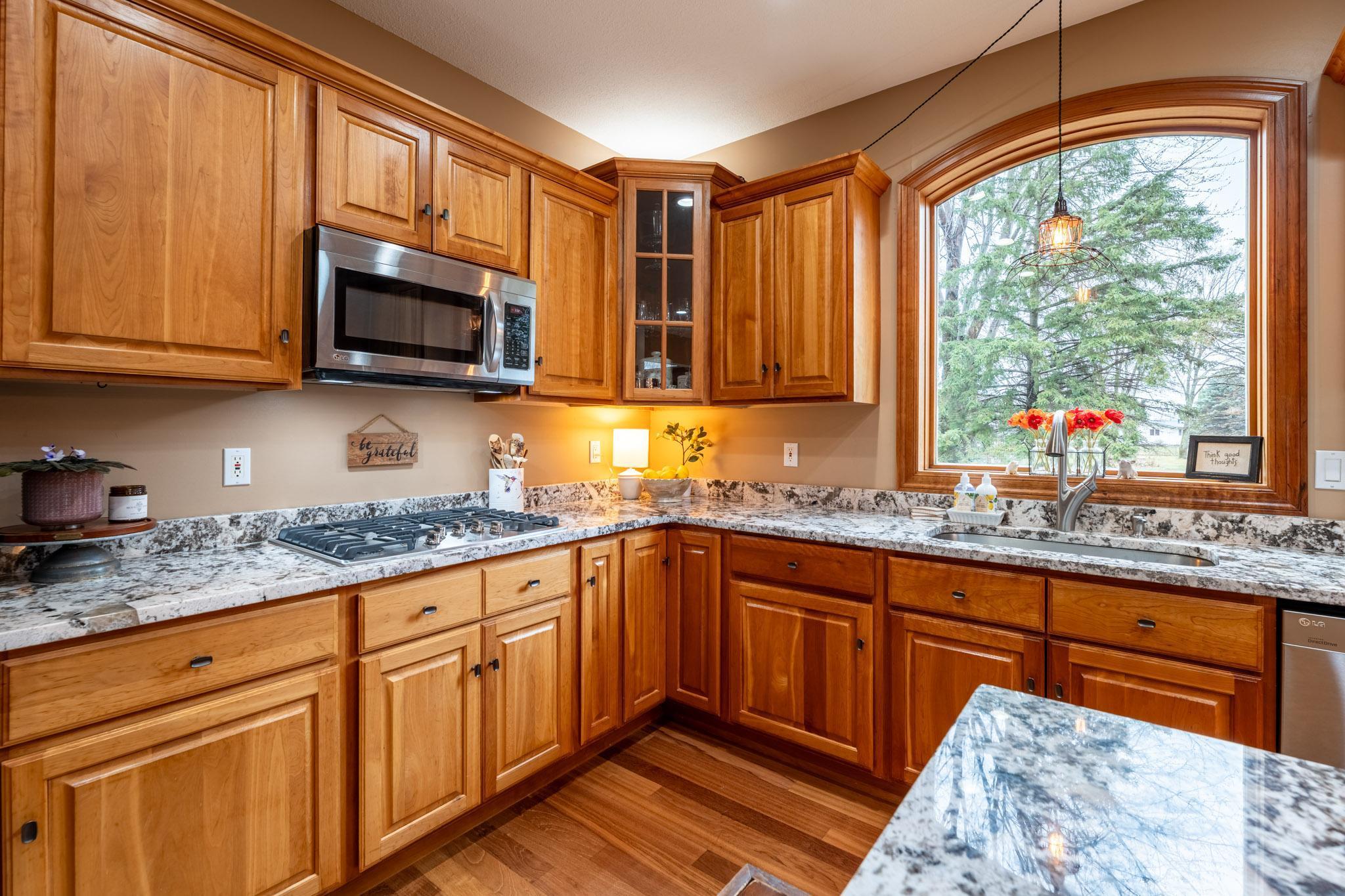 The kitchen has crown-molded cabinetry and beautiful display cabinets