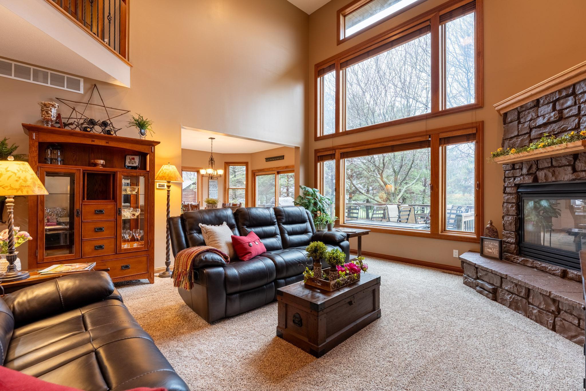 The grand living room with a two-story vault & wall of windows. Don't worry - the blinds are remote-controlled!