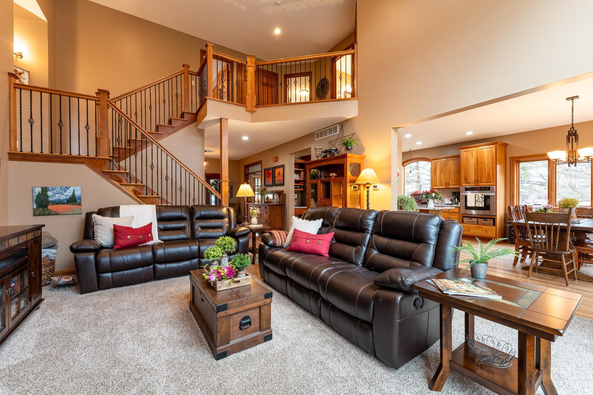 The main level offers a large foyer, front office, and half bath. It flows naturally into the impressive kitchen, informal dining room, and 2-story living room, plus a convenient main-level laundry.
