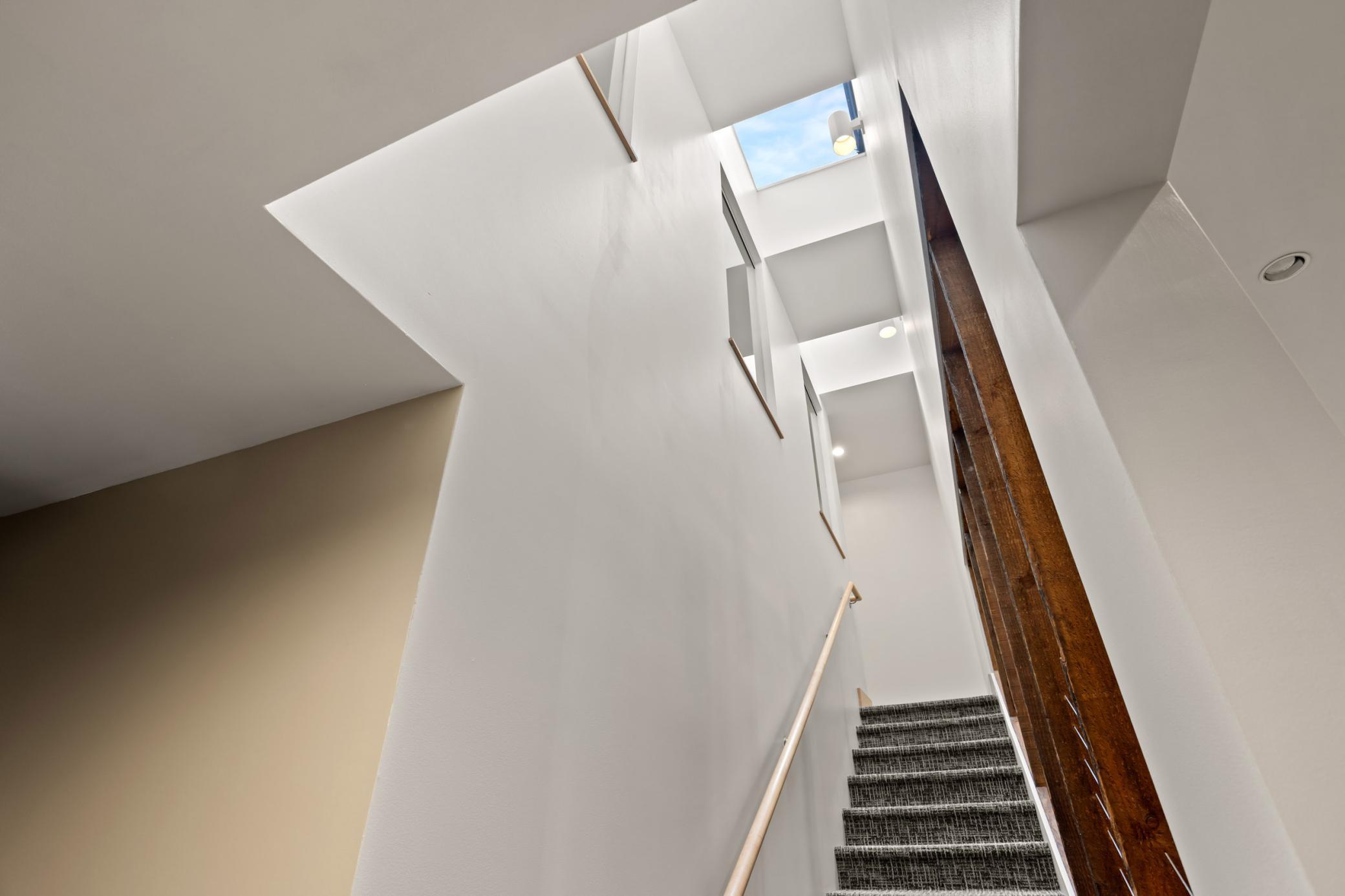 Stairwell to upper level space - skylights let in abundant natural light