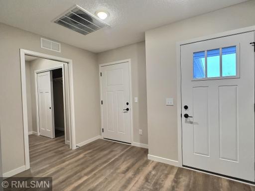 Here is front entrance showing the access to the garage and laundry room.