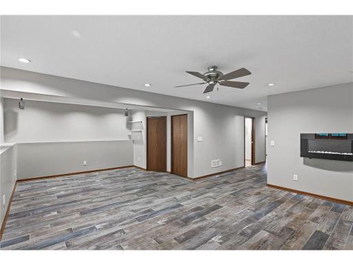 Lower level living space featuring surround sound speakers and newer tile