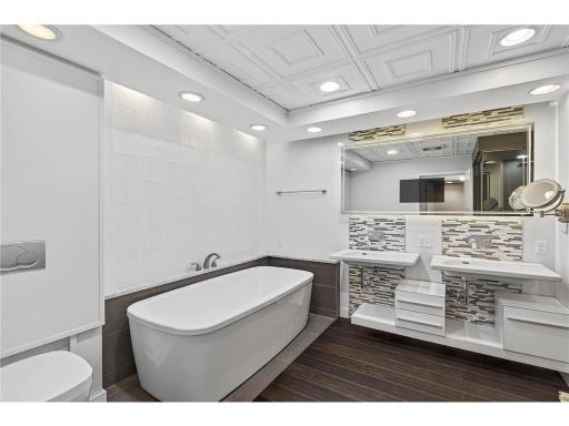 Unwind in the oversized soaking tub, offering the perfect place to relax and enjoy a peaceful, spa-inspired retreat at home.