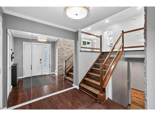 Spacious entry foyer with a large coat closet featuring built-in organizers for effortless storage and everyday convenience.