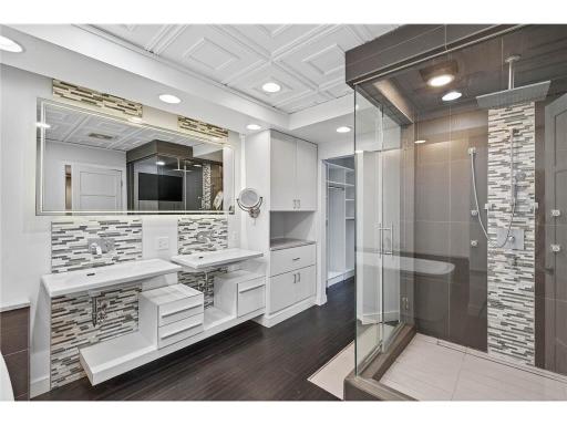 Upper main bath features dual sinks, large soaking tub, over-sized lighted mirror and steam shower